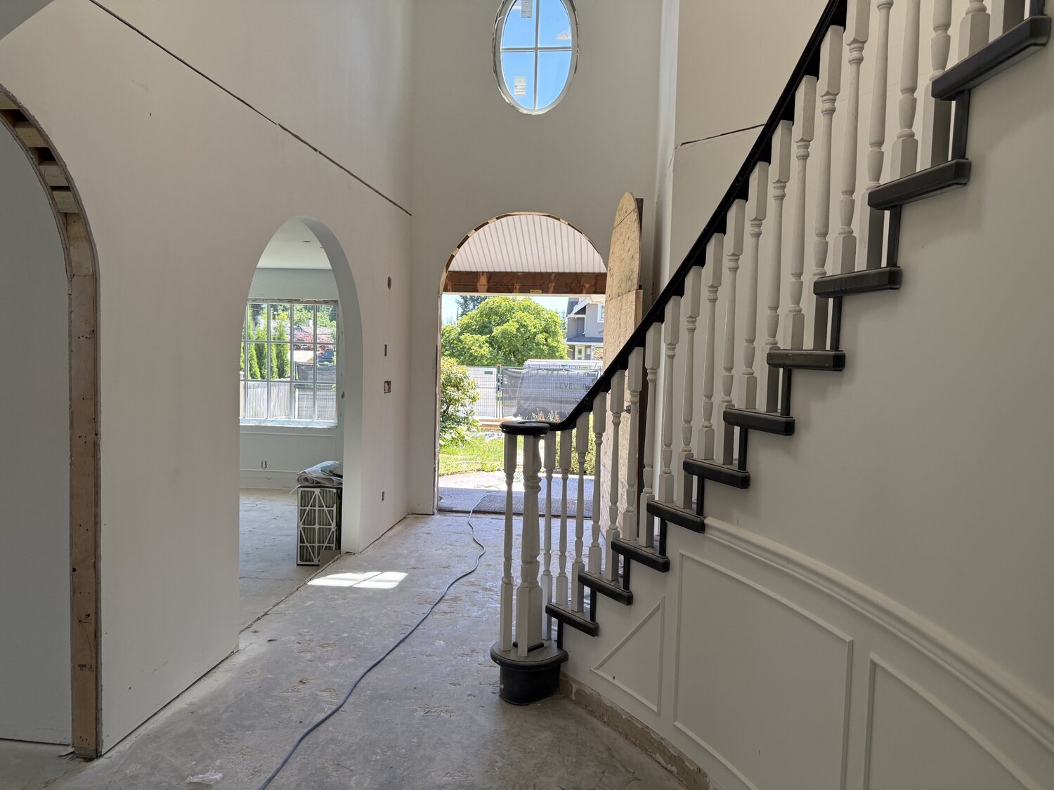 Two-storey foyer with round window and curved staircase, Viney Road renovation